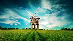 Windmill In Grass Field Wallpaper