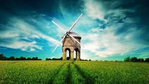 Windmill In Grass Field Wallpaper