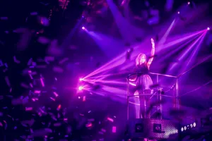 Woman In Club With Light Purple Lighting Wallpaper