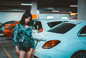 Woman Standing Beside Car In Parking Lot Wallpaper