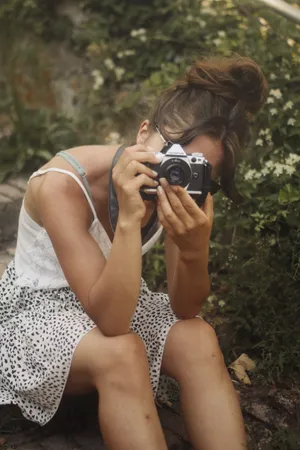 Woman Taking Garden Photo Wallpaper