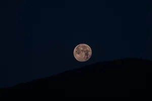 Wonder Of The Moon - Admiring The Moon On A Hilltop Wallpaper