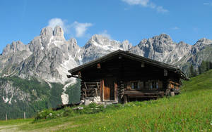 Wooden House With Snowy Mountain Wallpaper