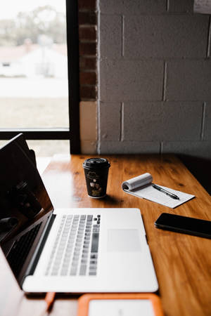 Wooden Iphone Desk Setup With Coffee Cup Wallpaper