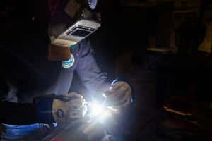 Working Together - Welders Joining Pieces Wallpaper