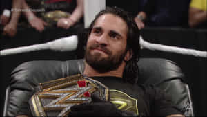 Wrestler Seth Rollins With Championship Belt Wallpaper