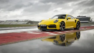 Yellow Porsche 911 In Empty Stadium Wallpaper