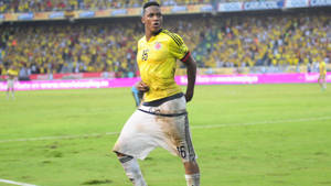 Yerry Mina In Yellow Jersey Wallpaper