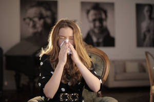 Young Woman Middle Of Sneeze Wallpaper