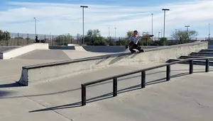 Youthful Enthusiasm: Boy Rollerblading At Skate Park Wallpaper