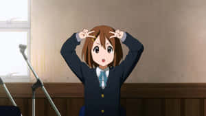 Yui Hirasawa Playing Her Guitar With Passion Wallpaper