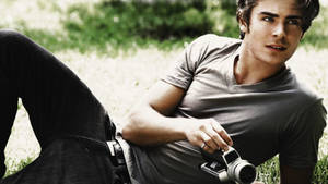 Zac Efron Holding A Camera Wallpaper