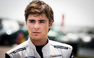 Zac Efron In Racing Suit Wallpaper