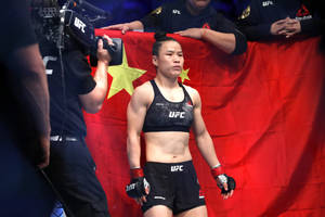 Zhang Weili Proudly Standing In Front Of Her Nation's Flag Wallpaper