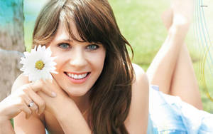 Zooey Deschanel Holding A White Flower Wallpaper